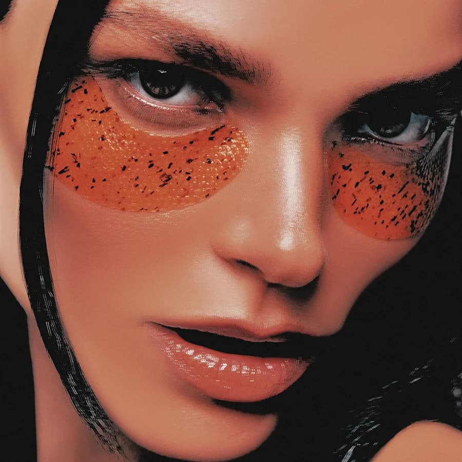 Glowvera model wearing tangerine under-eye patches